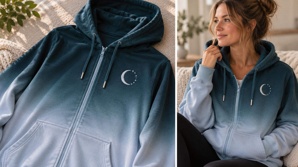 The Always Whole hoodie: deep night-sky navy with the crescent moon and stars embroidered in silver thread at the chest