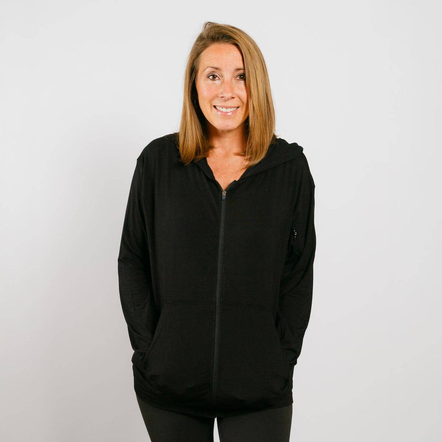 Woman wearing black bamboo IV zip hoodie with front zipper, shown from front view.