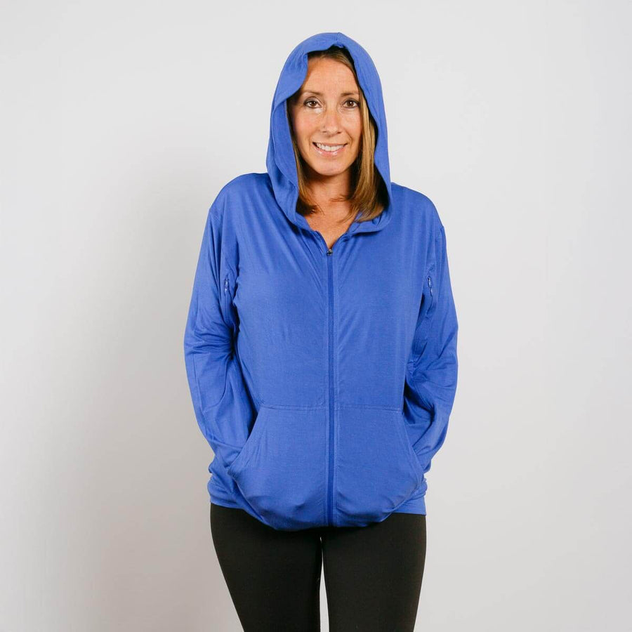 Woman wearing blue bamboo IV zip hoodie with hood up, front view.