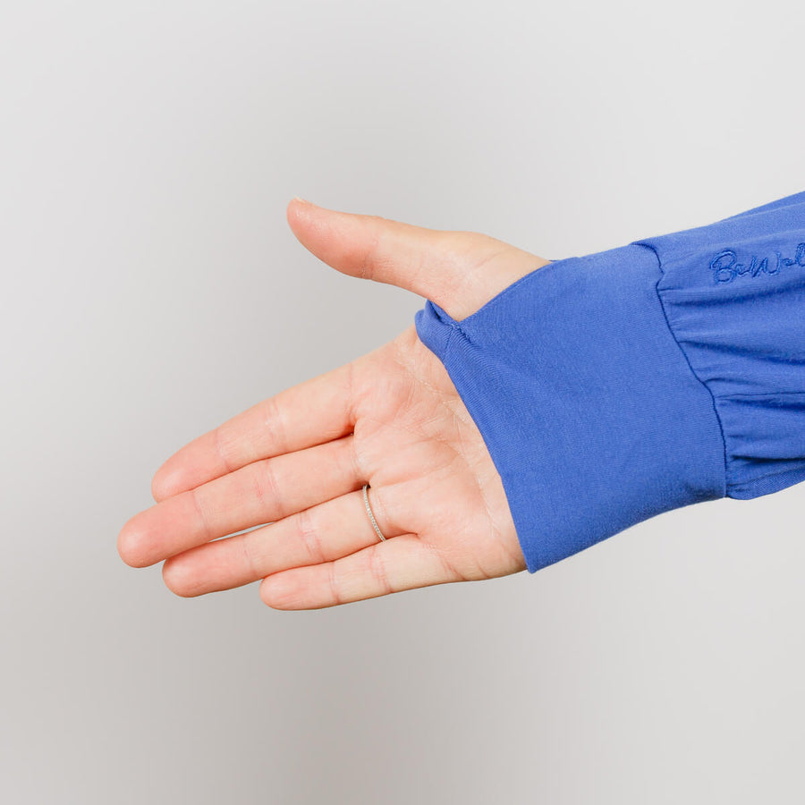 Person wearing blue Bamboo IV zip hoodie with arm zipper access visible on sleeve.