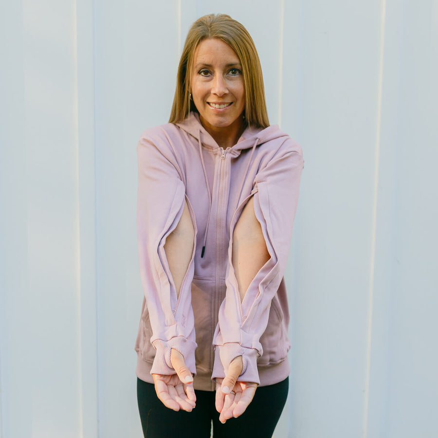 Woman wearing lavender IV zip hoodie with open sleeve zippers for arm access, front view.