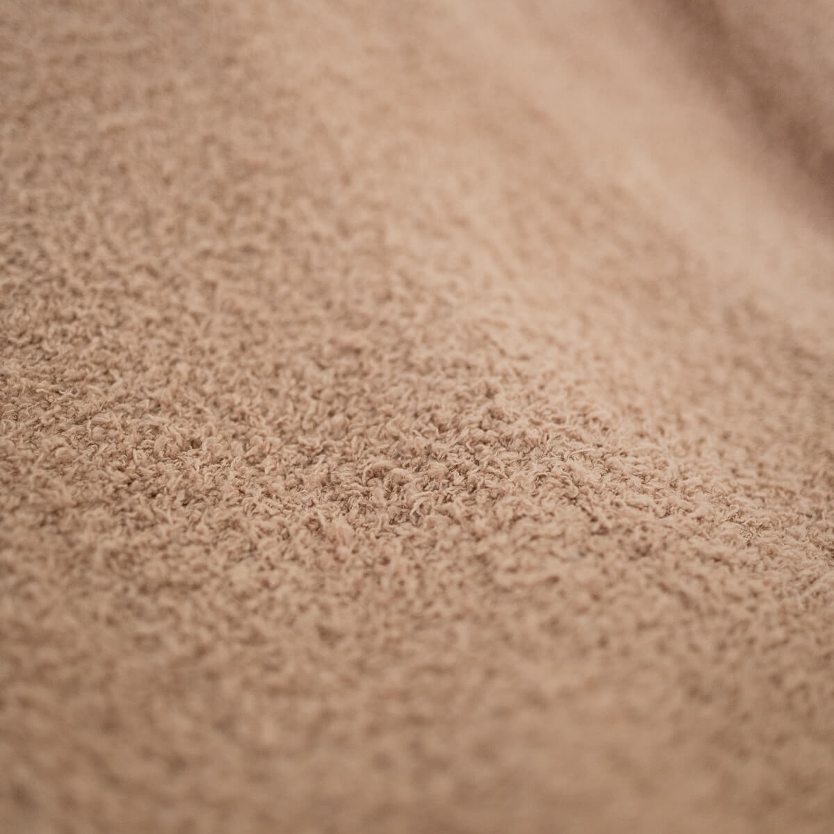 Close-up of brown, textured fabric.