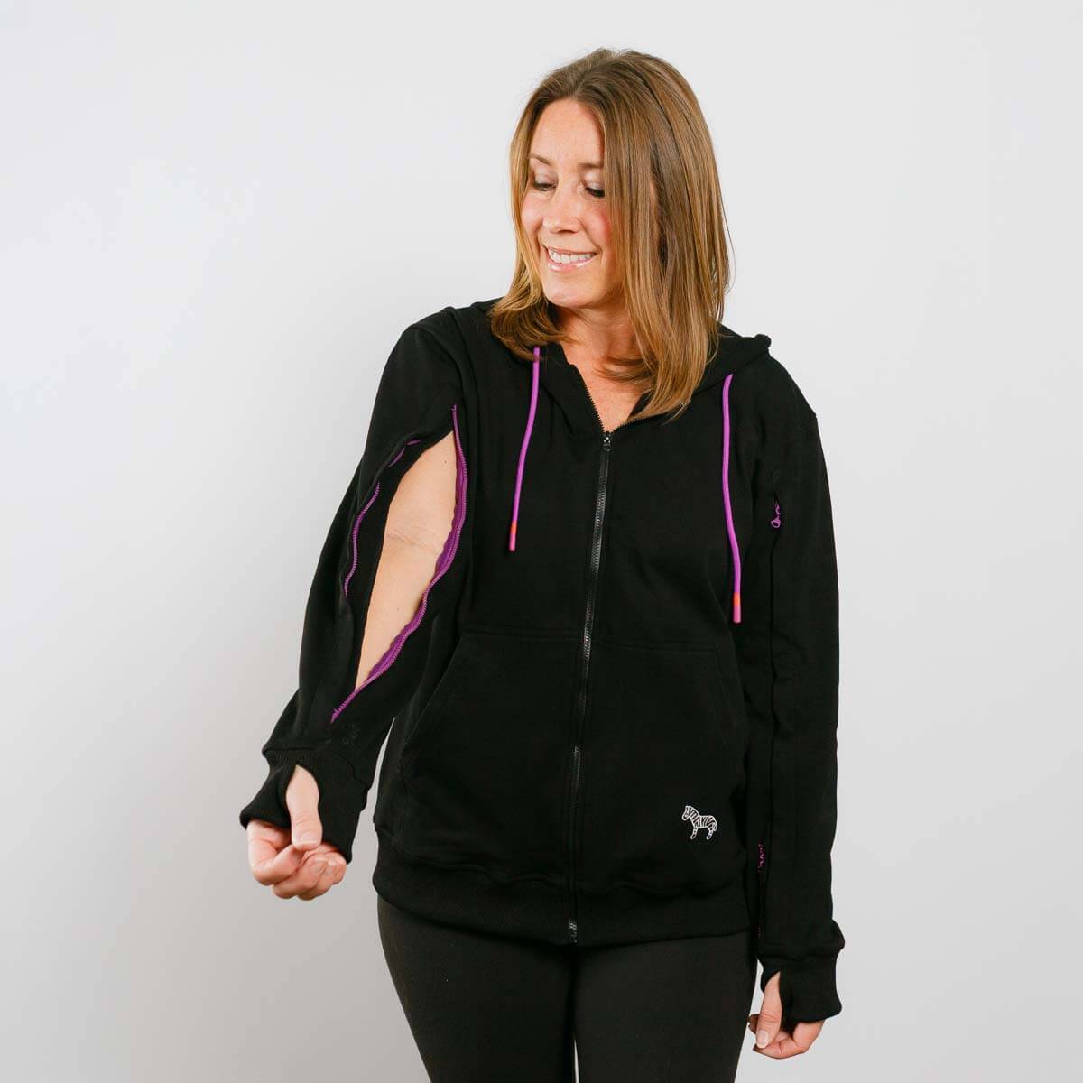 Woman wearing a black hoodie with purple accents on a plain background #NEW | Model is 5'3" 130lbs wearing size S