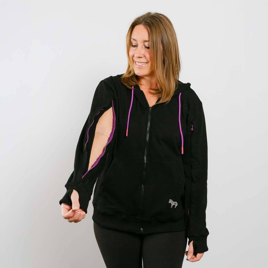 Woman wearing a black hoodie with purple accents on a plain background #NEW