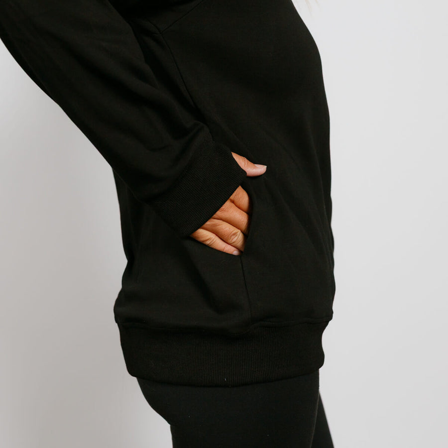 Black hoodie with ripped holes on the sleeve showing skin underneath.