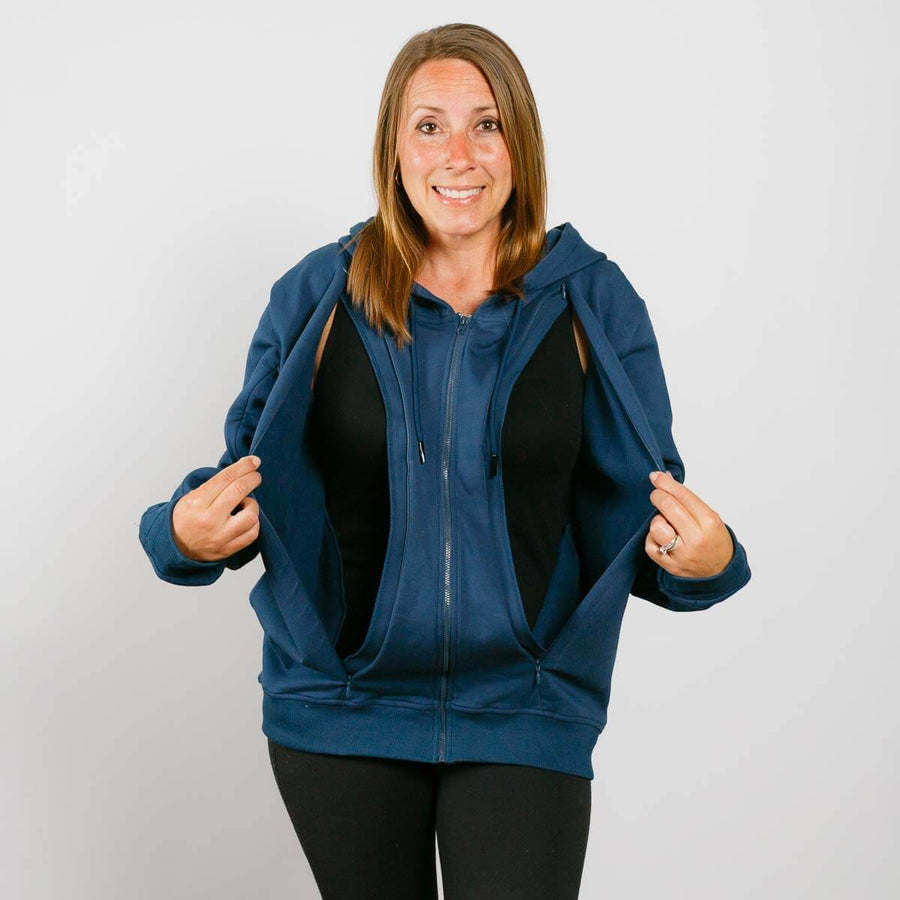 Woman wearing a blue zip-up hoodie over a black top on a plain white background #NEW
