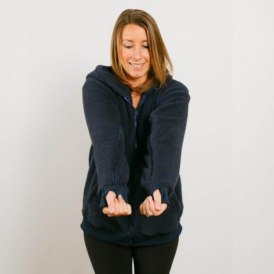 Woman wearing navy sherpa zip hoodie with front view showing full garment fit.