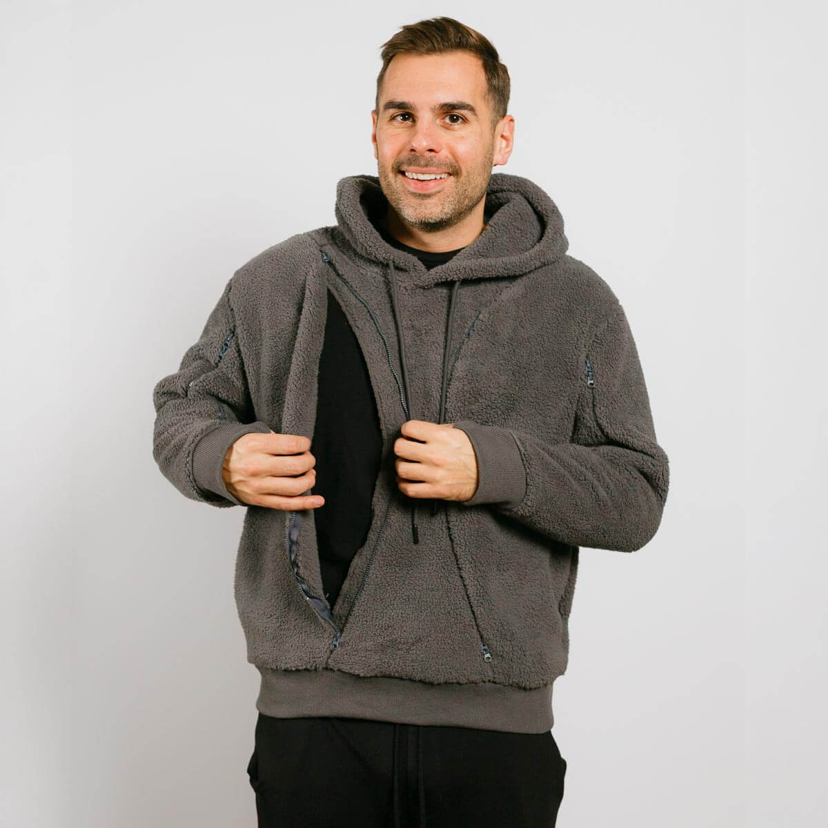 Man wearing a gray fleece hoodie against a plain background | Model is 5'8" 165lbs wearing size M