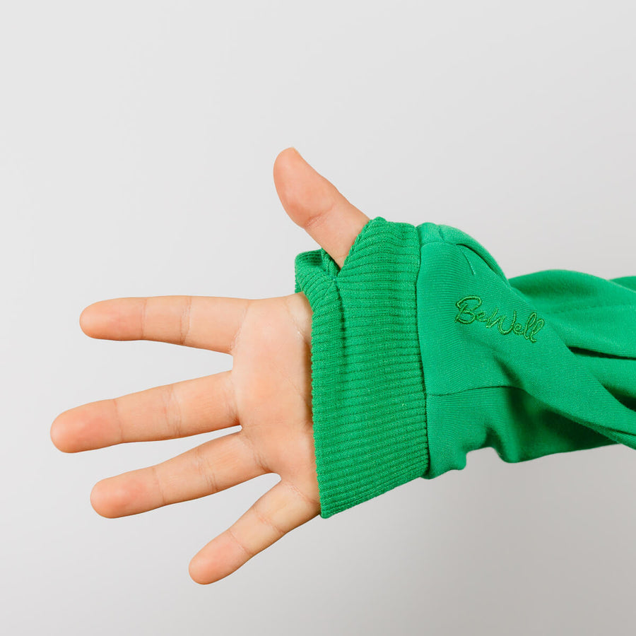 Child wearing green youth IV zip hoodie with sleeve access zipper detail visible on wrist.