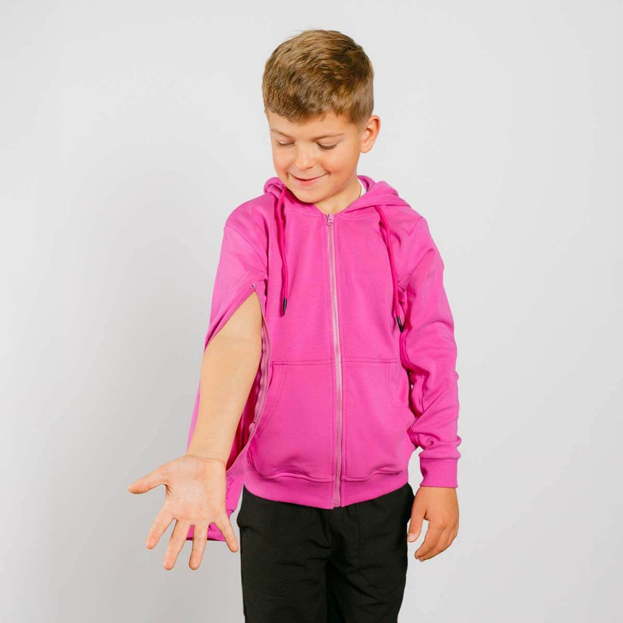 Boy wearing pink IV zip hoodie with left sleeve zipper access feature open.