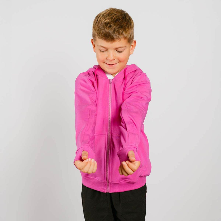 Young child wearing bright pink IV zip hoodie with front view showing arm access zippers.