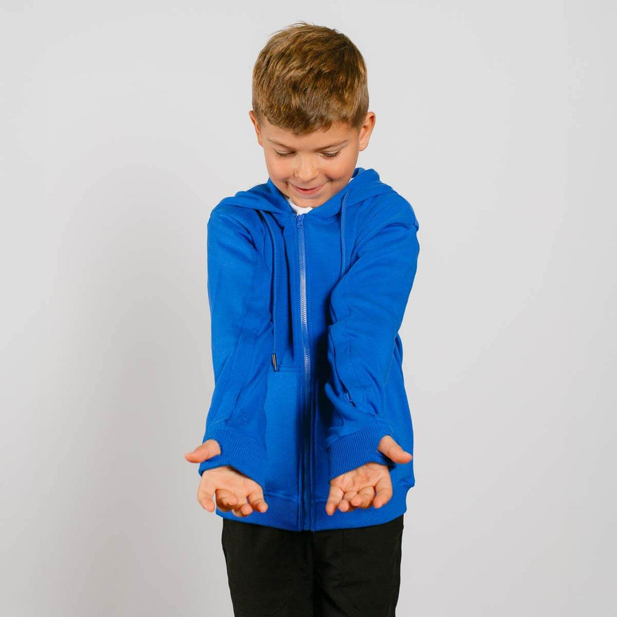 Young boy wearing bright blue IV zip hoodie with front view showing arm zipper access.