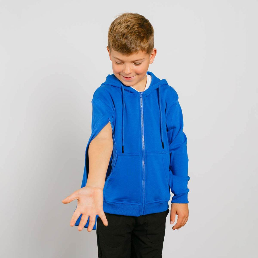 Boy wearing royal blue IV zip hoodie with left sleeve zipper access open, side view.