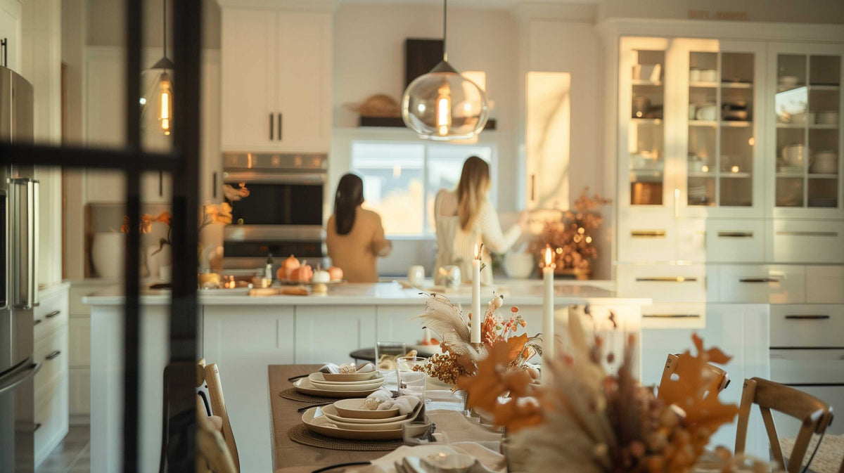 Elegant holiday dining table with dried flower centerpieces and place settings in a bright kitchen.
