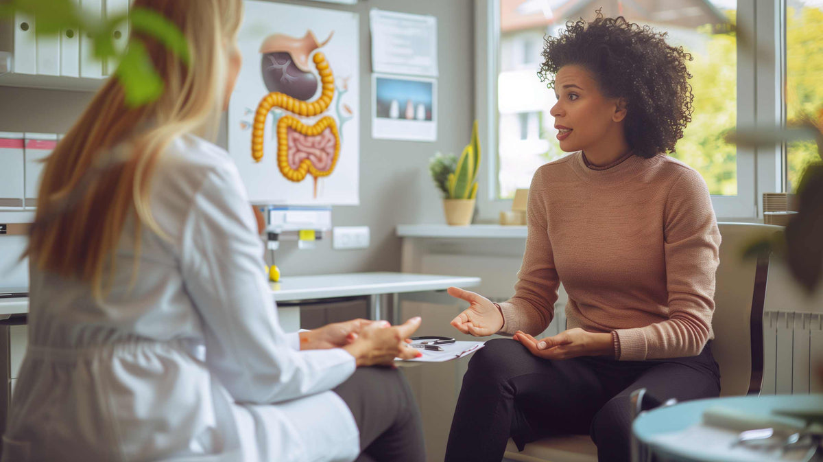 A healthcare provider discusses ostomy preparation with a patient in a bright medical office.