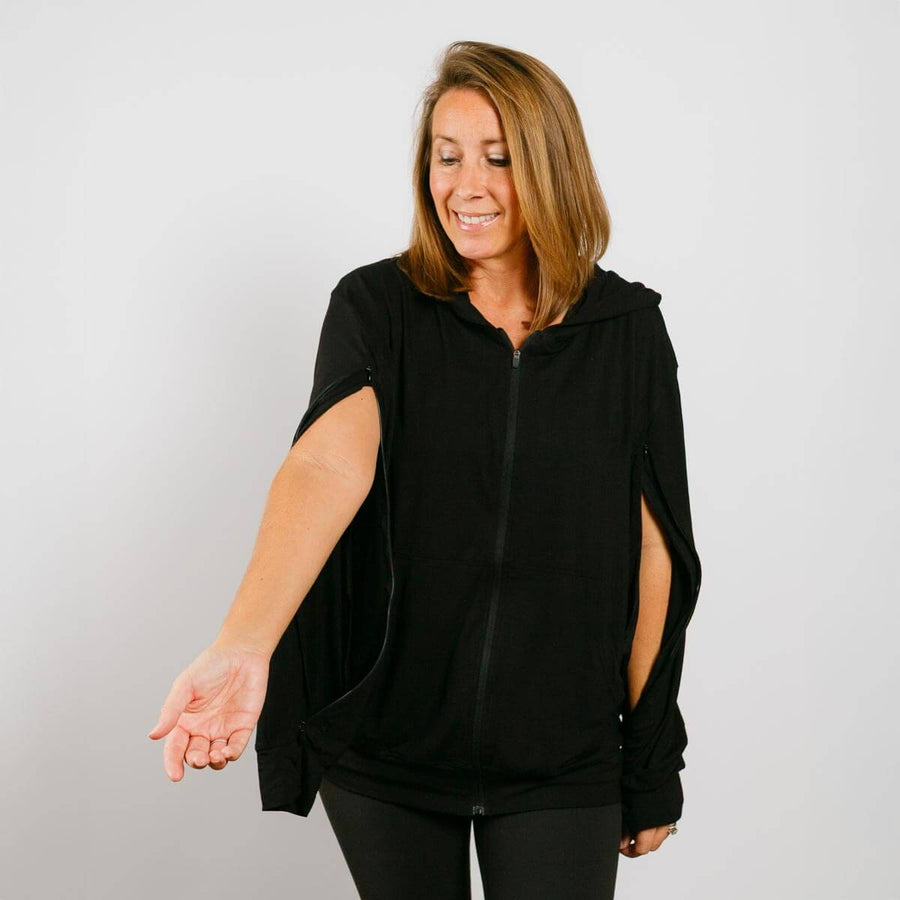 Woman wearing black bamboo IV zip hoodie with side sleeve opening, front view.