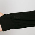 Person wearing black bamboo IV zip hoodie, close-up of left sleeve showing zipper access detail.
