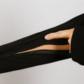 Person wearing black bamboo IV zip hoodie with left sleeve zipper open revealing arm access port.