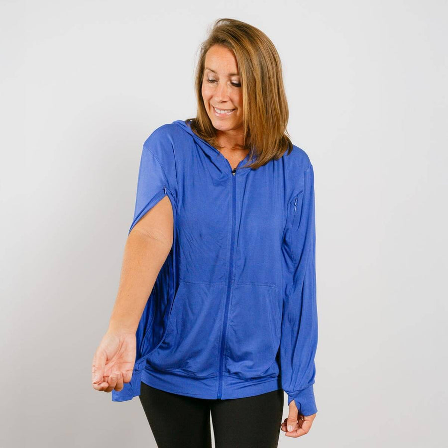 Woman wearing blue bamboo IV zip hoodie with left sleeve access opening visible.