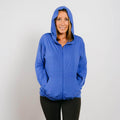 Woman wearing blue bamboo IV zip hoodie with hood up, front view.