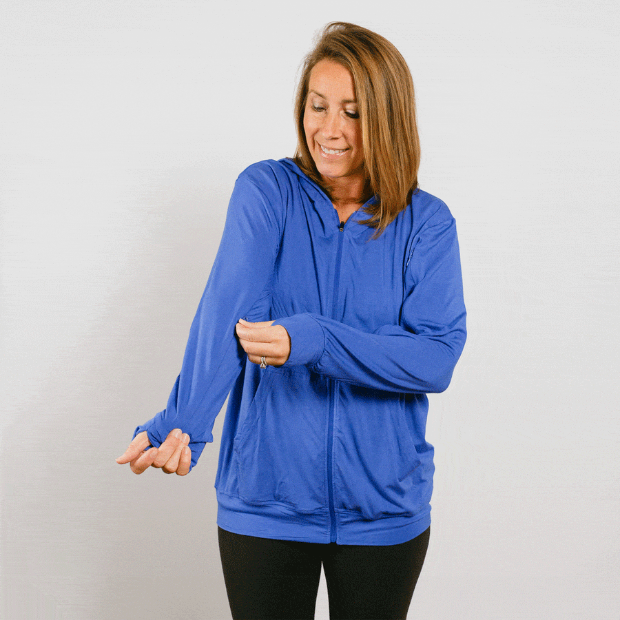 Woman wearing blue bamboo IV zip hoodie with front zipper open during treatment.