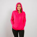 Woman wearing bright pink bamboo IV zip hoodie with hood up, front view.