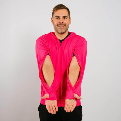 Man wearing a bright pink jacket with cut-out sleeves on a plain background | Model is 5'8" 165lbs wearing size M