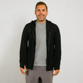 Man wearing black zip hoodie over gray t-shirt and gray pants, smiling at camera. | Model is 5'8" 165lbs wearing size M