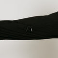 An arm showing the sleeve of a black zip hoodie showing two zippers on a seam on the inner arm.