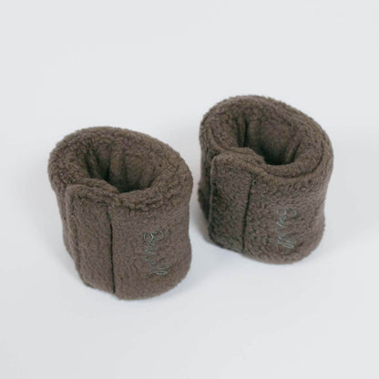 Two dark gray belt buffers or seatbelt port pads displayed on a white background.