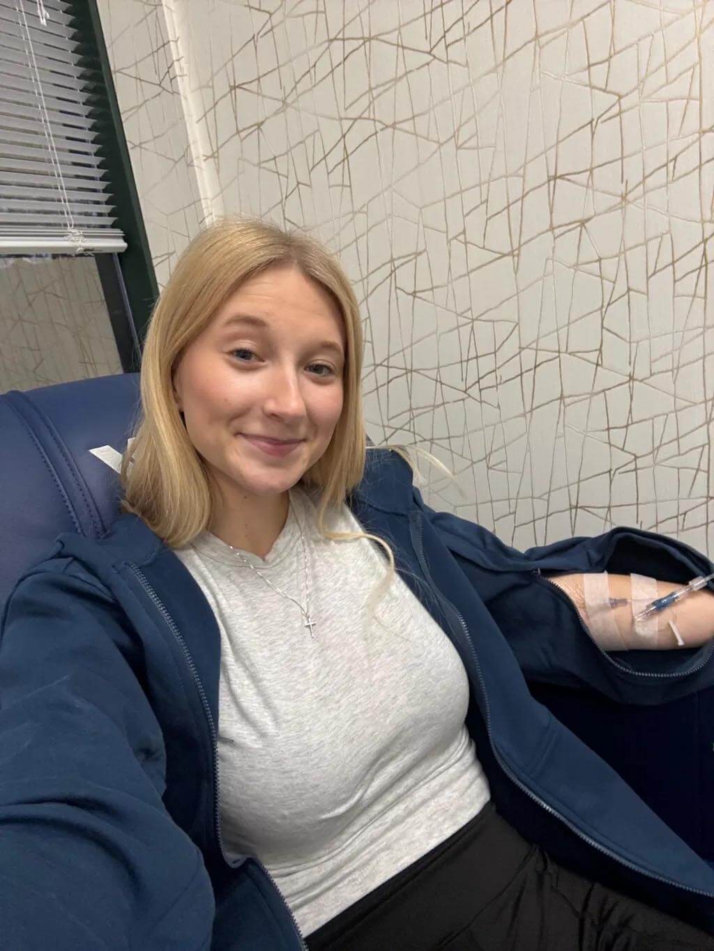 Gift-giver's loved one wearing the BeWell IV Zip Hoodie during treatment