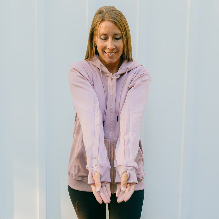 Woman wearing lavender IV zip hoodie with sleeve access zippers, front view.