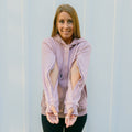 Woman wearing lavender IV zip hoodie with open sleeve zippers for arm access, front view.