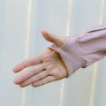 Person wearing lavender IV zip hoodie with arm access zipper detail visible on sleeve.