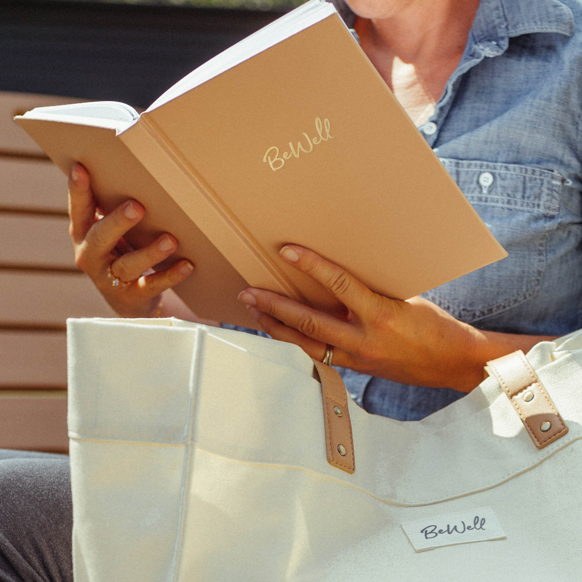 A woman holding a BeWell IBD Journal