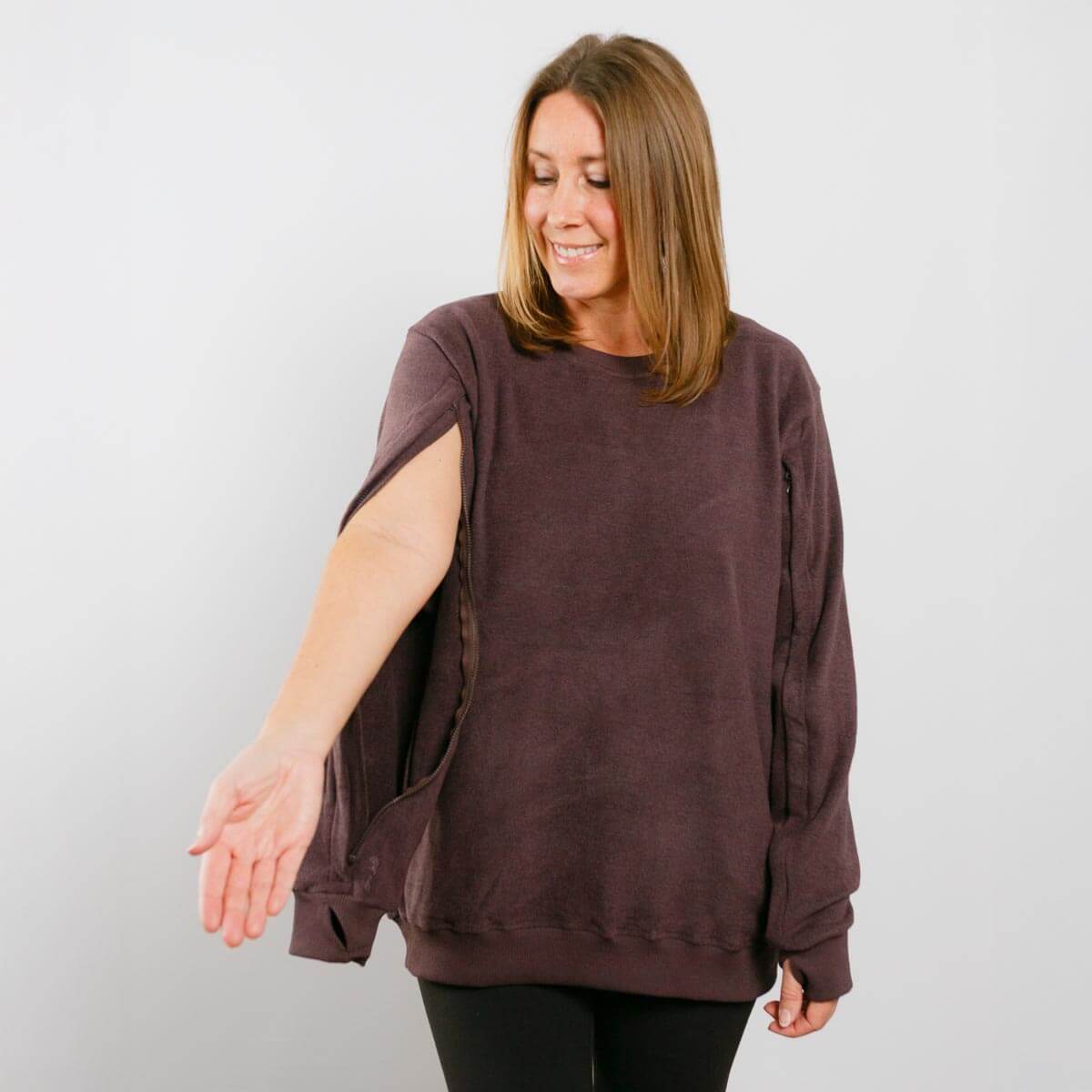 Woman wearing burgundy IV crewneck with left sleeve access opening visible.