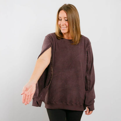 Woman wearing burgundy IV crewneck with left sleeve access opening visible.