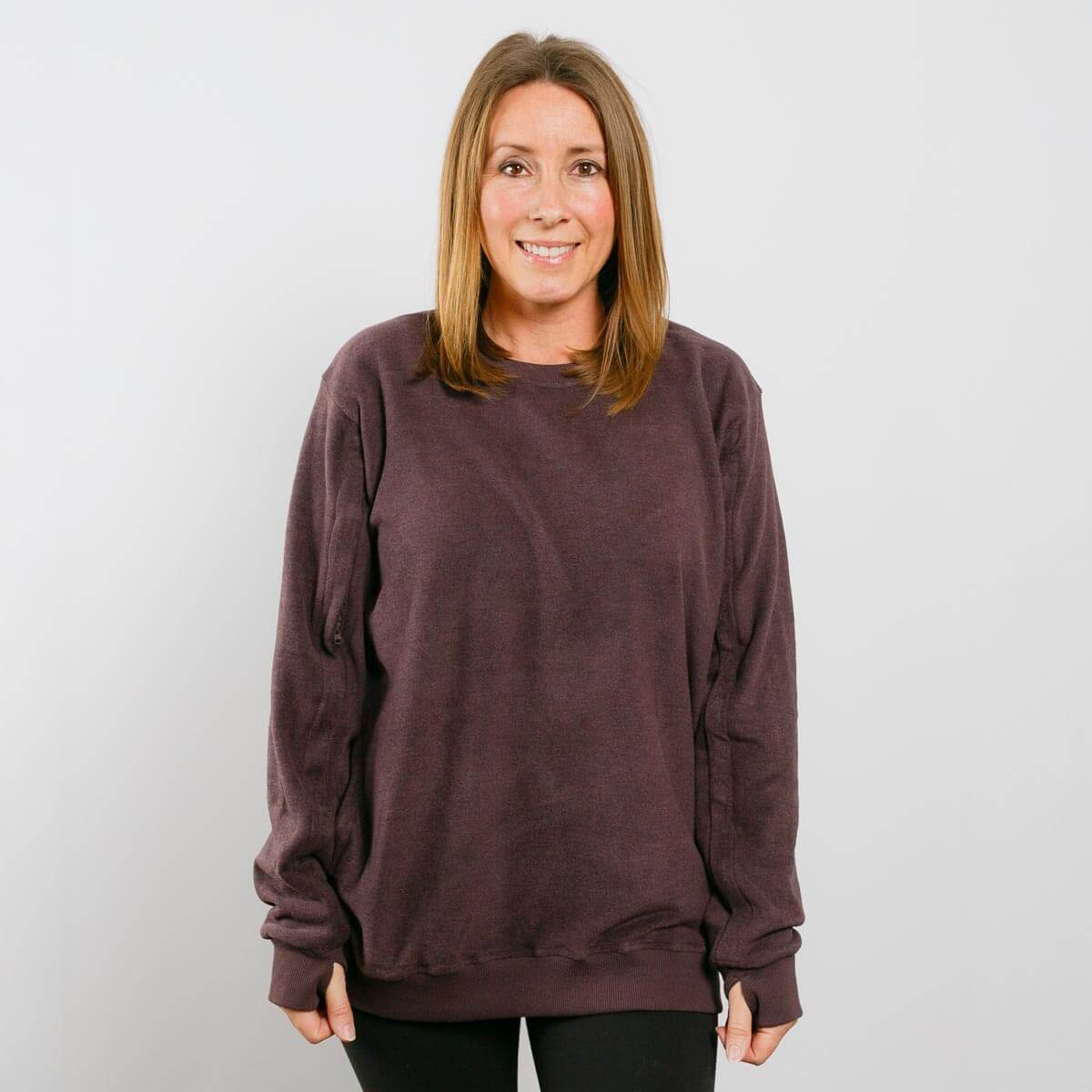 Woman wearing burgundy IV crewneck sweatshirt, front view.