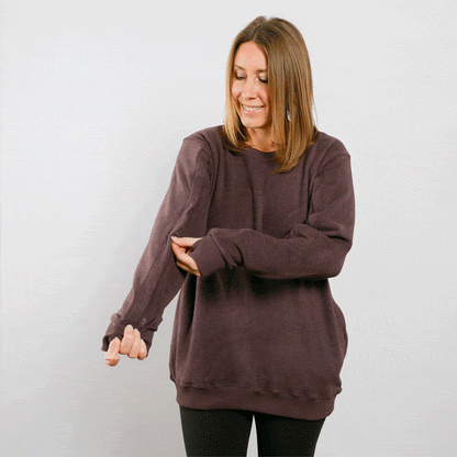 Woman wearing mauve IV crewneck with side arm access, front view.