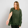 Woman wearing olive green IV crewneck with left sleeve access opening visible.