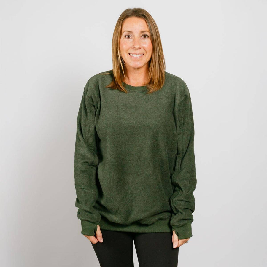 Woman wearing olive green IV crewneck sweatshirt, front view.