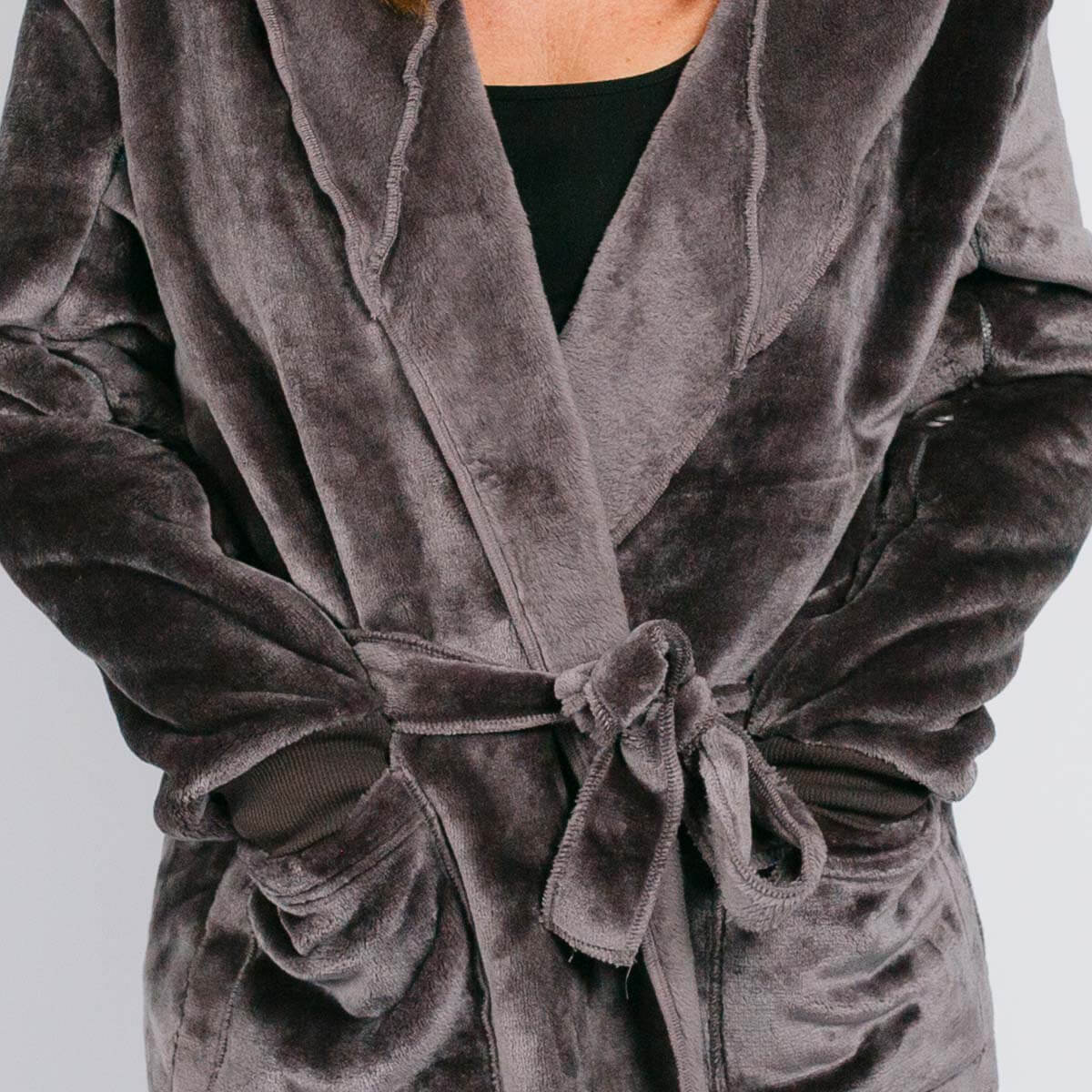 Person wearing a gray velvet robe tied at the waist with a black shirt underneath.
