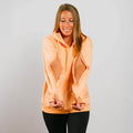Woman wearing peach IV zip hoodie with side chest access openings, front view.