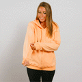Woman wearing peach zip hoodie with left arm access zipper in front view.