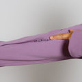 Person's hand pointing to the zipper details on a lavender purple zip hoodie sleeve.