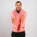 Man wearing a pink hoodie with cut-out sleeves on a plain background  | Model is 5'8" 165lbs wearing size M