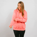 Woman wearing coral pink IV zip hoodie with front zipper, looking down at left sleeve access.