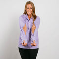 Woman wearing lavender IV zip hoodie with open arm zippers for medical access, front view.