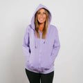 Woman wearing lavender IV zip hoodie with hood up, front view showing full zipper.