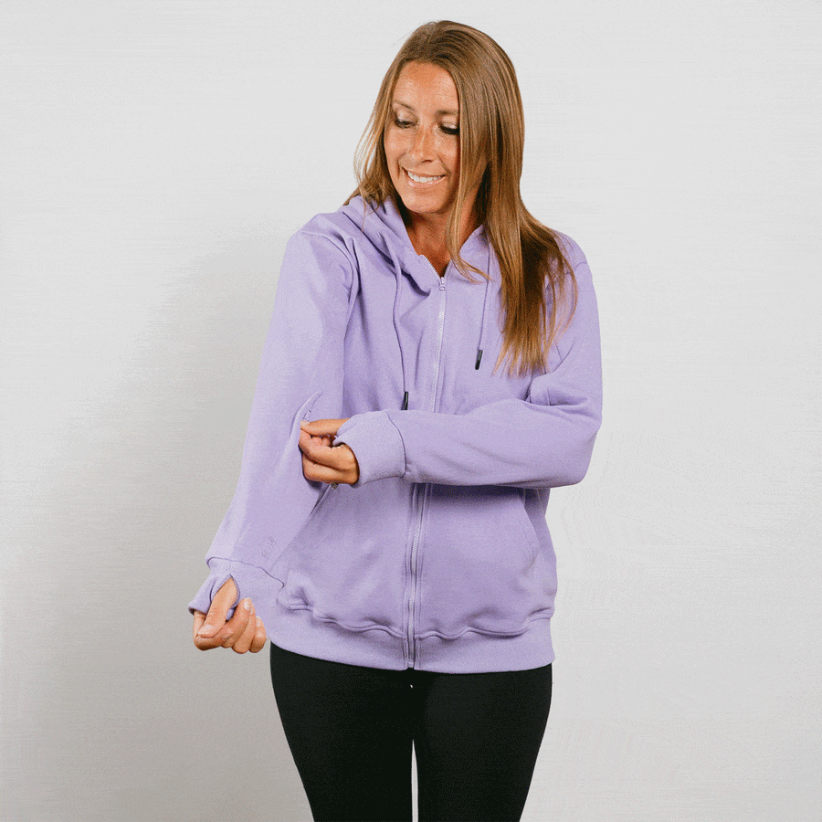 Woman wearing lavender IV zip hoodie with front zipper, standing in lifestyle pose.